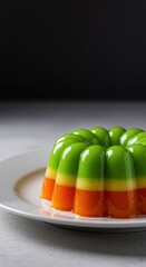 Classic brightly colored molded fruit jelly dessert, glistening and wobbly, served simply on a white plate ready for consumption at a gathering ,gelatin ,sweet ,pure