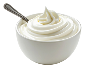 Yogurt dessert in a white bowl with a metal spoon resting beside it on a plain background