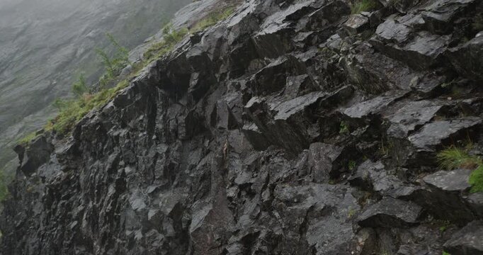 Rain falling on a steep rock wall in the norwegian mountains