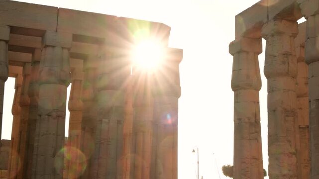 Sun shines through columns in square at Luxor Temple