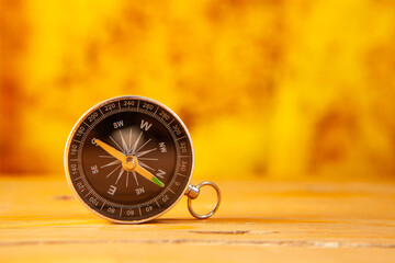 Compass on wooden background, travel and adventure concept, copy space