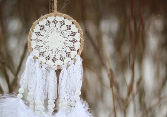 Dream catcher in winter outdoor season snow mascot bohemian style ethnic object hanging on the tree nature cozy calm photo beautiful background lifestyle thing boho lovely craft dreamcatcher 