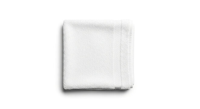 Soft white towel neatly folded on plain background