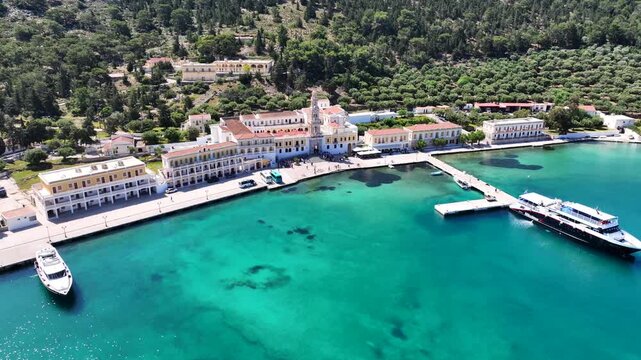 Aerial drone cinematic video of iconic bay and Monastery of Archangel Michael Panormitis, Symi island, Dodecanese, Greece