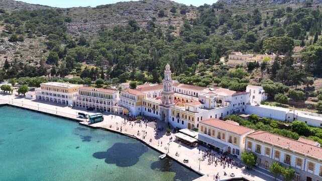 Aerial drone cinematic video of iconic bay and Monastery of Archangel Michael Panormitis, Symi island, Dodecanese, Greece