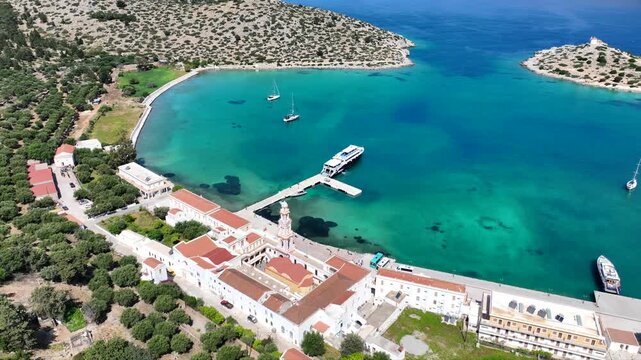 Aerial drone cinematic video of iconic bay and Monastery of Archangel Michael Panormitis, Symi island, Dodecanese, Greece