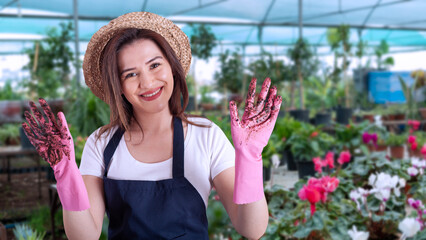 young woman florist in greenhouse