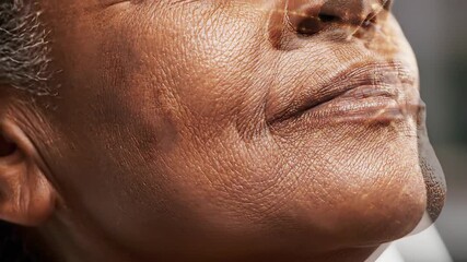 A detailed closeup of a mature African American persons face showcasing natural skin texture and wrinkles enhanced with a glowing digital grid overlay representing advanced facial recognition technol. - Powered by Adobe