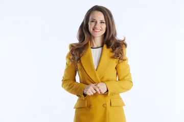 Fototapete Altes Krankenhaus Beelitz A friendly and confident businesswoman in a bright yellow blazer smiles directly at the camera with hands clasped, conveying approachability and professionalism.  © Alliance