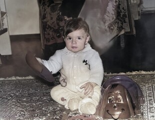Vintage portrait of a little girl holding a toy. Retro photo from 1995.