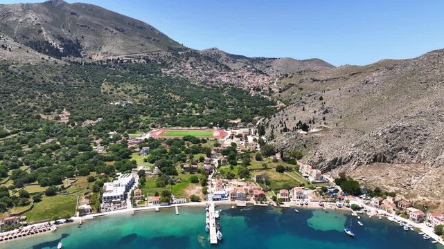 Aerial drone cinematic video of picturesque fjord shaped bay of Pedi in island of Symi, Dodecanese, Greece