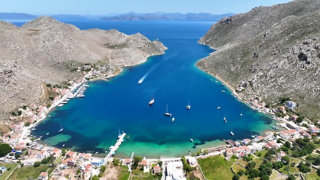 Aerial drone cinematic video of picturesque fjord shaped bay of Pedi in island of Symi, Dodecanese, Greece