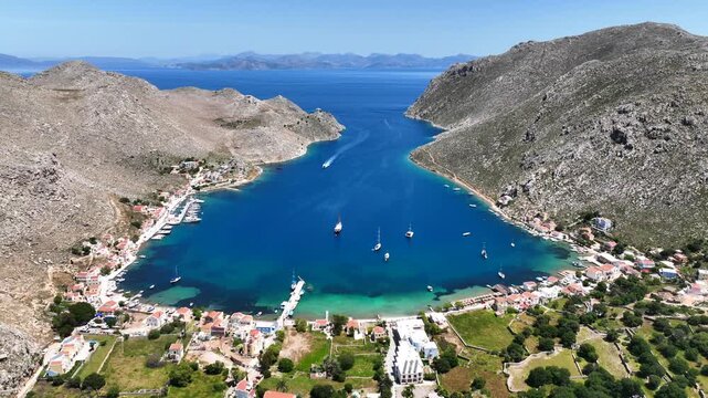 Aerial drone cinematic video of picturesque fjord shaped bay of Pedi in island of Symi, Dodecanese, Greece