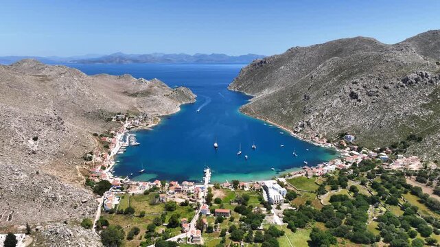 Aerial drone cinematic video of picturesque fjord shaped bay of Pedi in island of Symi, Dodecanese, Greece
