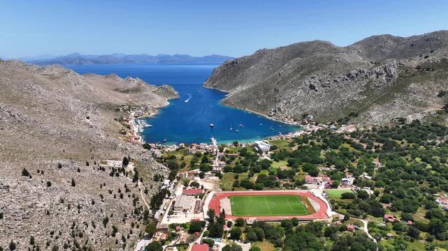 Aerial drone cinematic video of picturesque fjord shaped bay of Pedi in island of Symi, Dodecanese, Greece