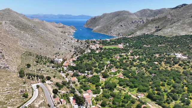 Aerial drone cinematic video of picturesque fjord shaped bay of Pedi in island of Symi, Dodecanese, Greece