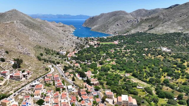 Aerial drone cinematic video of picturesque fjord shaped bay of Pedi in island of Symi, Dodecanese, Greece