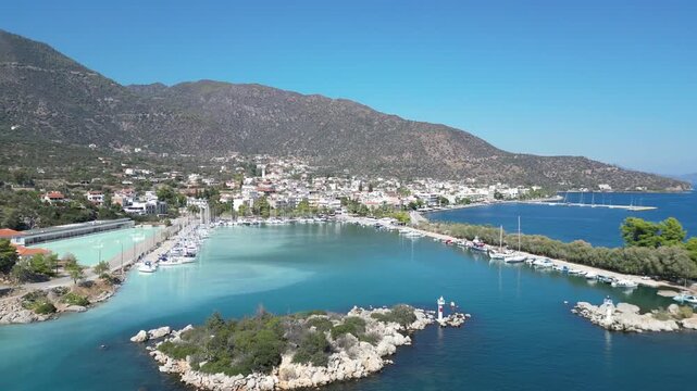 Aerial View of Methana Port and Volcanic Peninsula in Greece.
High-angle drone footage showing the picturesque harbor of Methana with turquoise volcanic waters.