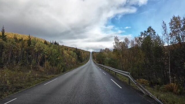 Picturesque motorhome point of view driving on an empty road in Senja, Norway, during autumn