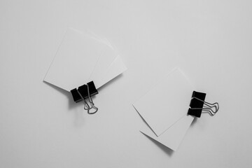 A close-up macro shot of a white paper clip and metallic fasteners organized as essential business...