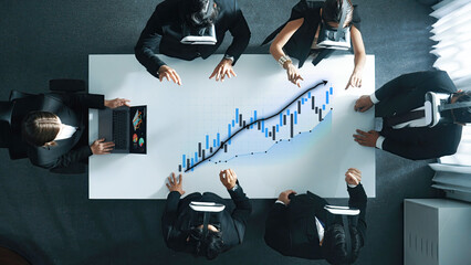 A business team utilizes virtual reality technology to analyze financial growth data in a modern office setting, showcasing innovative collaboration and engagement. Axiom