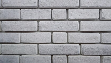 close up of a white brick wall with subtle texture and a few gray bricks
