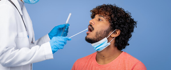 A medical worker is taking a swab from a patient in a clinical environment. The patient is wearing a mask and sitting calmly. The worker is dressed in medical attire and gloves.