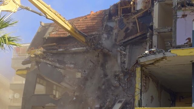 Demolition for Reconstruction of Houses using an Excavator in a Construction Site Footage.
