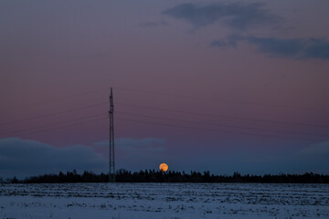 Full moon in frosty winter evening near Jindrichuv Hradec town