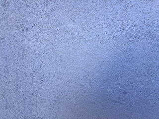 Real plaster wall surface with fine rough texture and soft blue color. Minimal architectural background, concrete wall detail, abstract exterior surface ideal for design, copy space and texture use.
