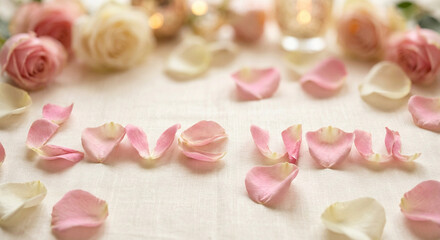 Romantic 'LOVE' message spelled with pink rose petals on a soft background.