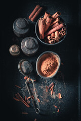 Heap of cinnamon sticks on a background