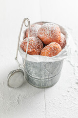 Yummy and hot mini doughnuts as a tasty snack.
