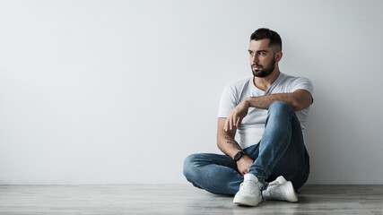 Lonely handsome man sad, stressed in self-isolation, suffering agoraphobia, depression. Serious...