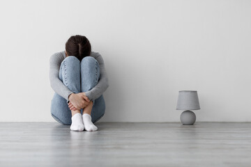 Worried sad millennial woman suffering from depression and mental illness, lady feeling lonely...