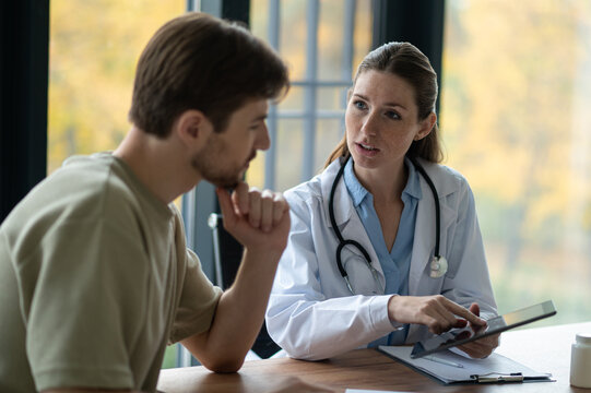 Female doctor in a lab coat giving prescription to the patient