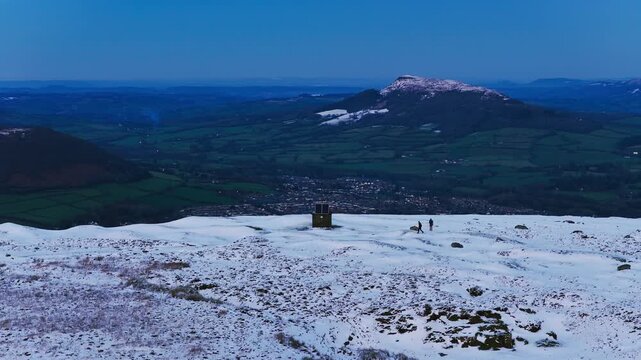 4K Aerial View of Abergavenny in the distance ontop of mountain Known as Blorenge South Wales UK Drone footage Snow on mountains