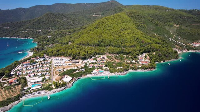 Aerial Cinematic Drone Flyover of Panormos Bay and Milia Beach &mdash; Scenic Turquoise Coastline with Lush Pine Forests, Skopelos Island Northern Sporades Greece