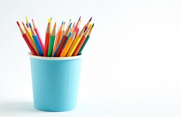 Fototapeta premium Colorful wooden pencils in a blue paper cup. Pencils arranged vertically in a container for drawing and art projects. Creative supplies for school and education.