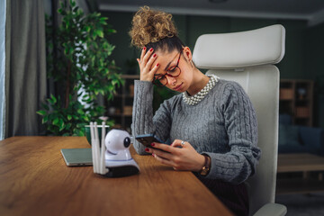 Woman experiencing stress using a smart phone controlling smart home security