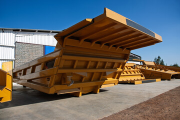 Huge Empty Yellow Mining Dump Truck Body Dump Box for Heavy Mining Equipment © poco_bw