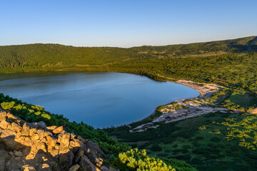 Serenity of a calm lake surrounded by lush greenery in Russia