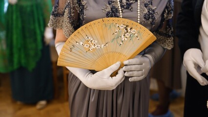 Elegant lady in victorian gown holding fan