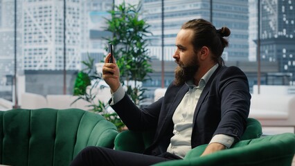 Rude furious director yelling at his partners on teleconference call, screaming and accusing them of incompetence. Aggressive irritated boss throwing documents around, difficult relations. Camera B.