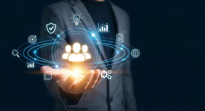 Businessman holding futuristic glowing icons of team members and business data, human resources management and leadership concept - Powered by Adobe