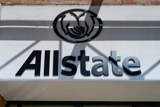 Allstate Insurance branded signage mounted on a commercial office storefront, representing insurance services, corporate branding, and financial service operations