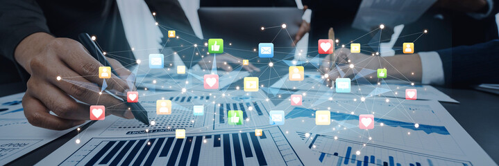 Close-up of hands working on data analysis with visual digital icons highlighting health and technology metrics, emphasizing collaboration and innovation in the workplace. Trope