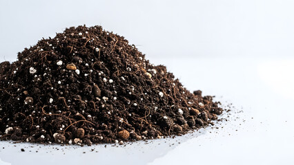 Pile of potting soil on light background for plant seedlings  
