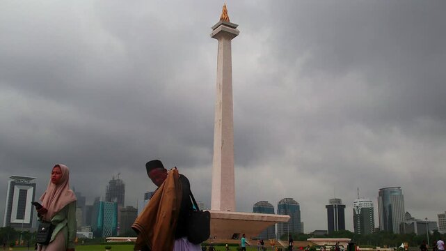 Timelapse view of Monas (National Monument) with cloudy skies in the background, showing dramatic weather conditions and an iconic landmark in Jakarta&rsquo;s city cen