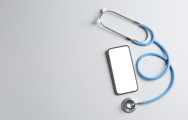 Telehealth. Smartphone and stethoscope on light background, flat lay. Space for text